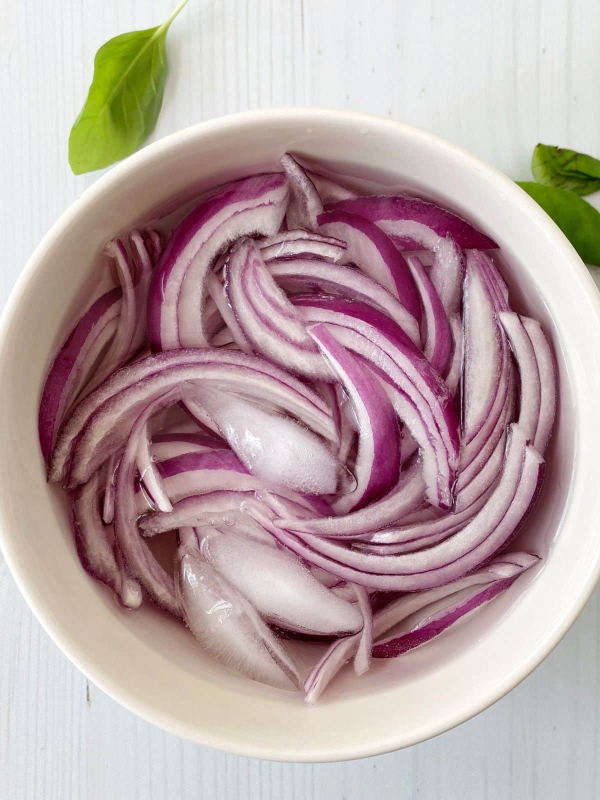 bowl of sliced onions in water