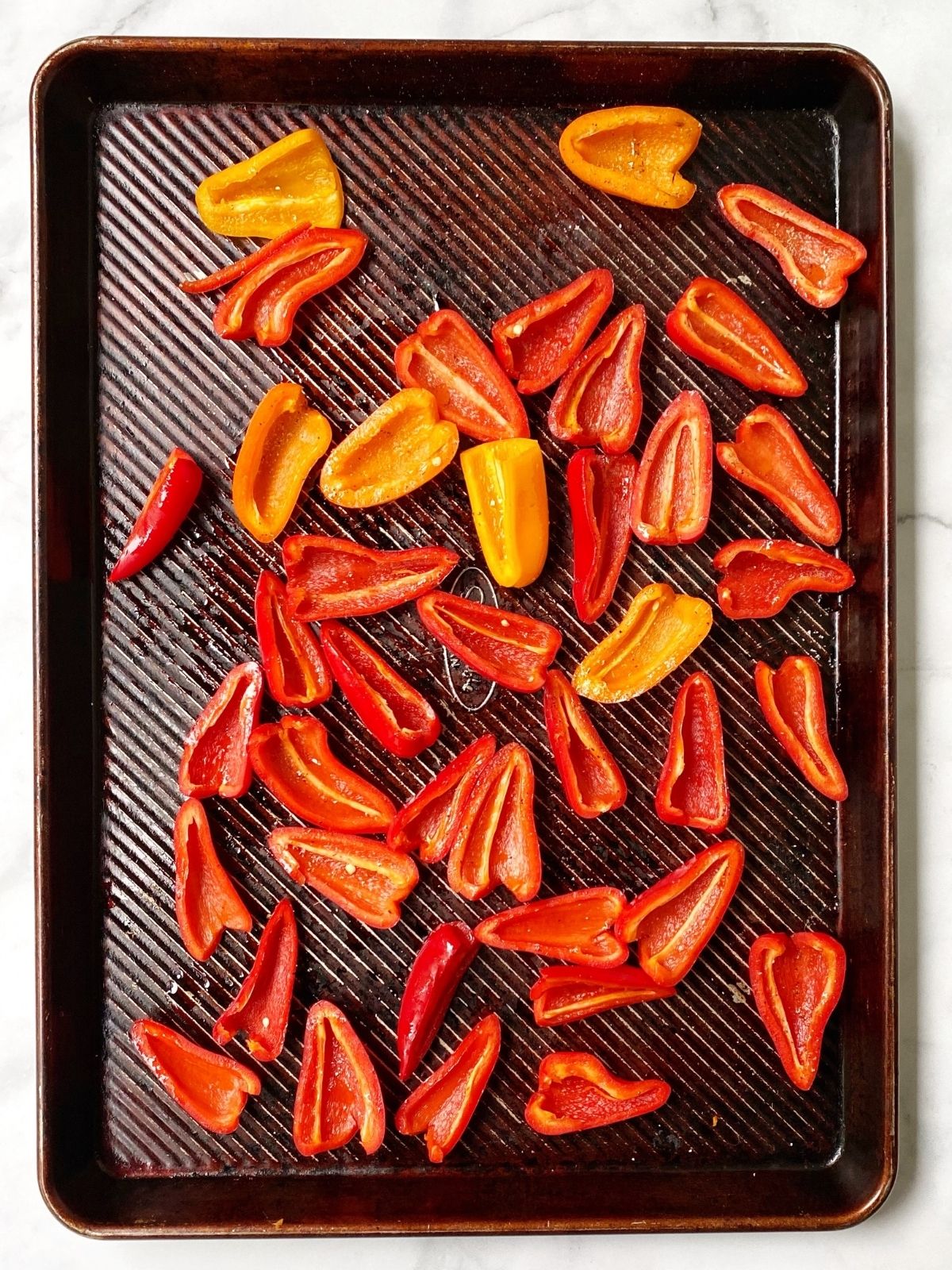 sheet pan of unroasted peppers