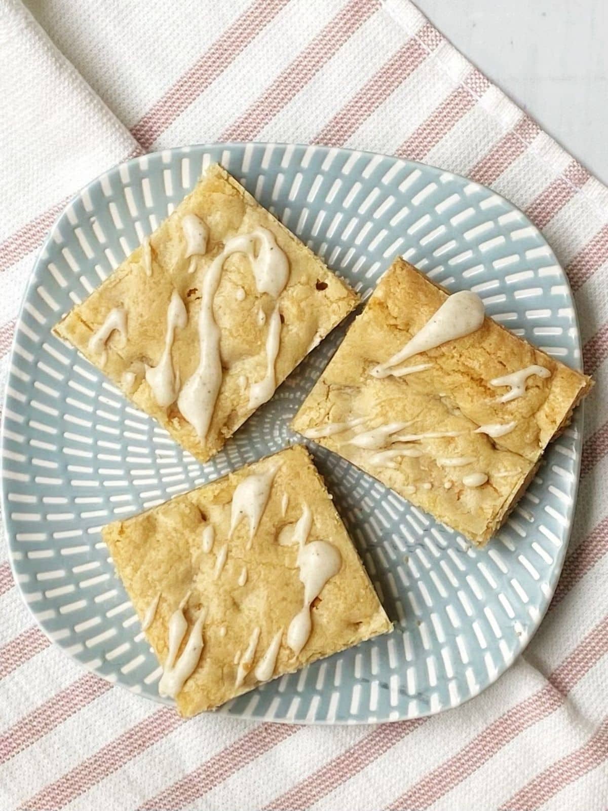 cookie bars with icing on a plate