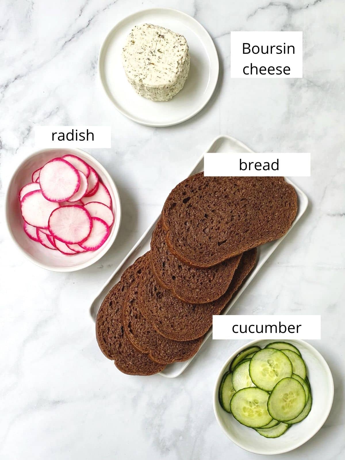 array of ingredients - bread, Boursin cheese, radish, and cucumber