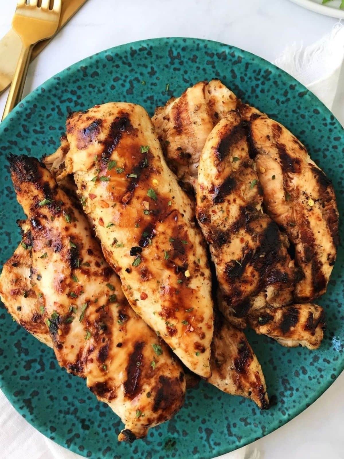 close up of plate of grilled chicken