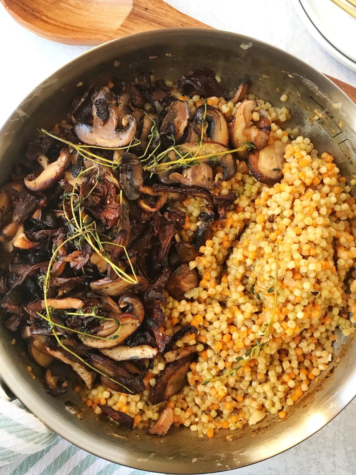 full skillet of sauteed mushrooms with couscous