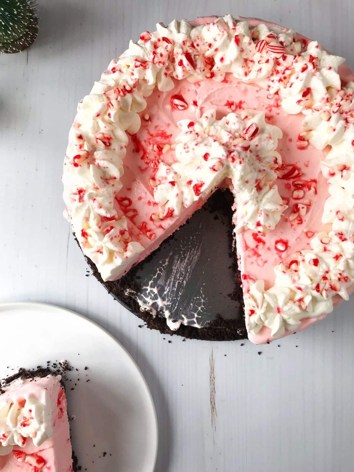 overhead picture of whole pie with a slice missing and a slice on a white plate