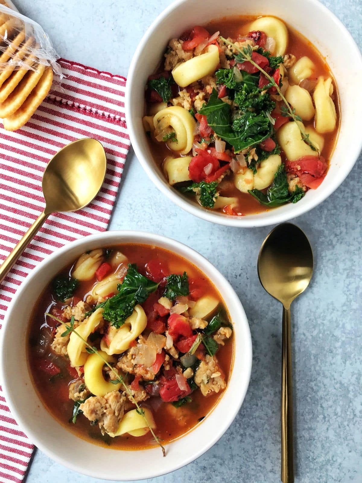 overhead shot of two bowls of soup with spoons laying on the side