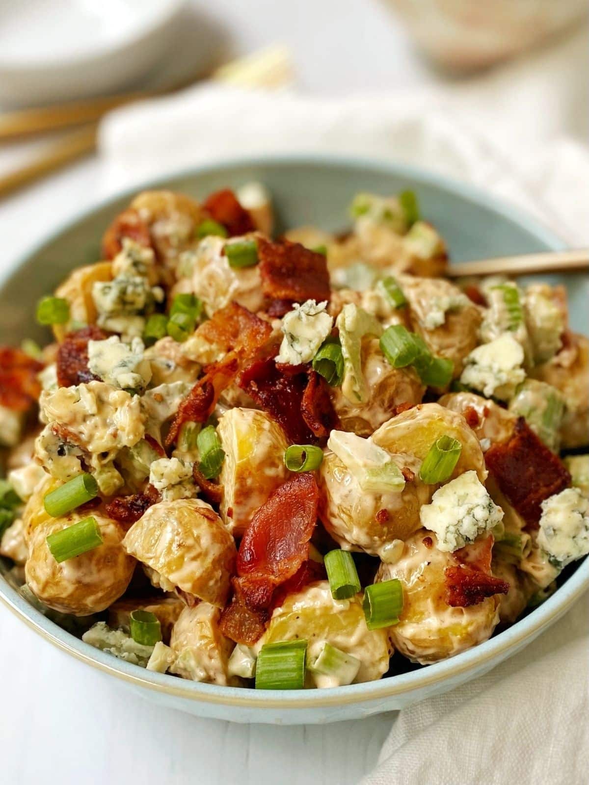 spoon in a bowl of buffalo potato salad.