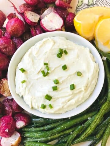 plate of roasted radishes and green beans with butter dip.