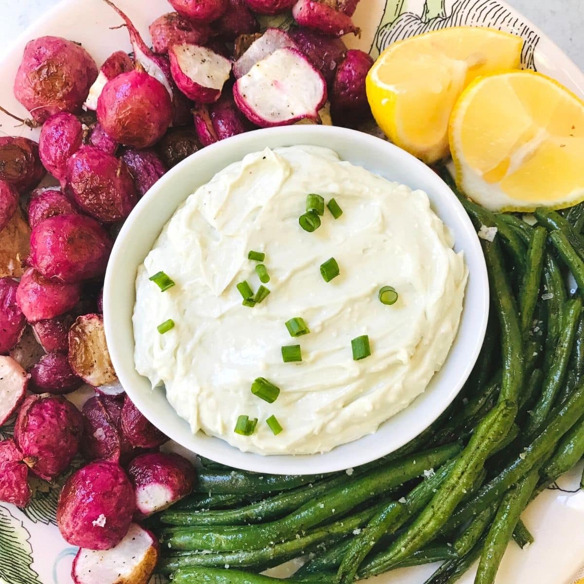 plate of roasted radishes and green beans with butter dip.