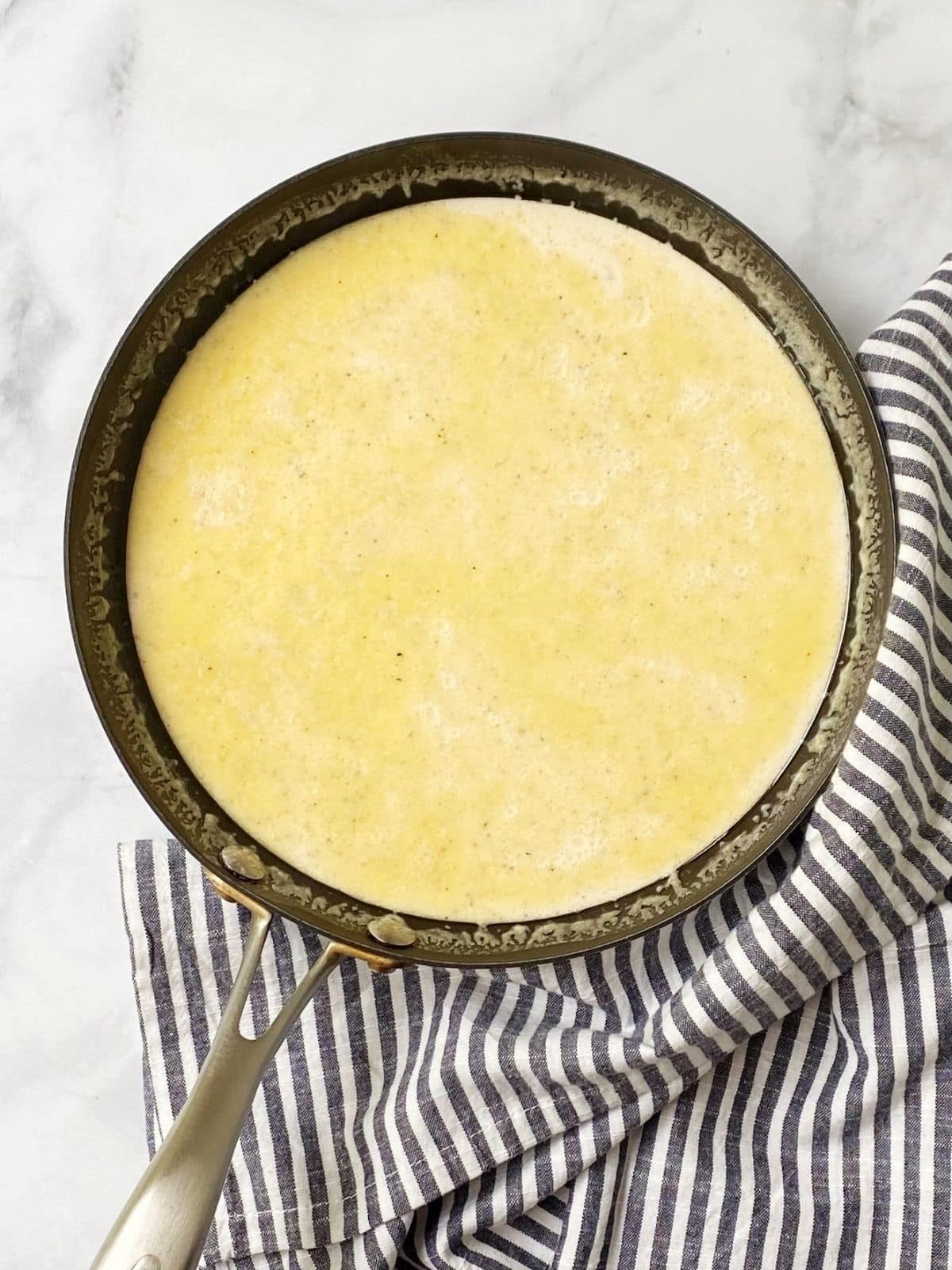 milk and butter warming in a skillet