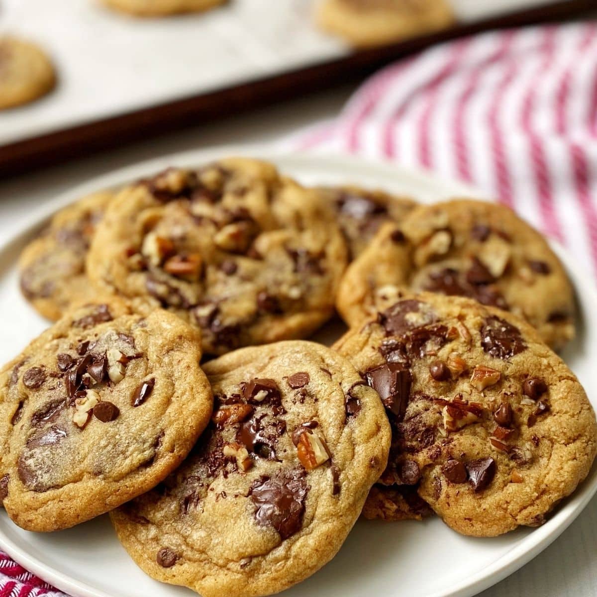 close up of dark chocolate chip cookies on a plate.