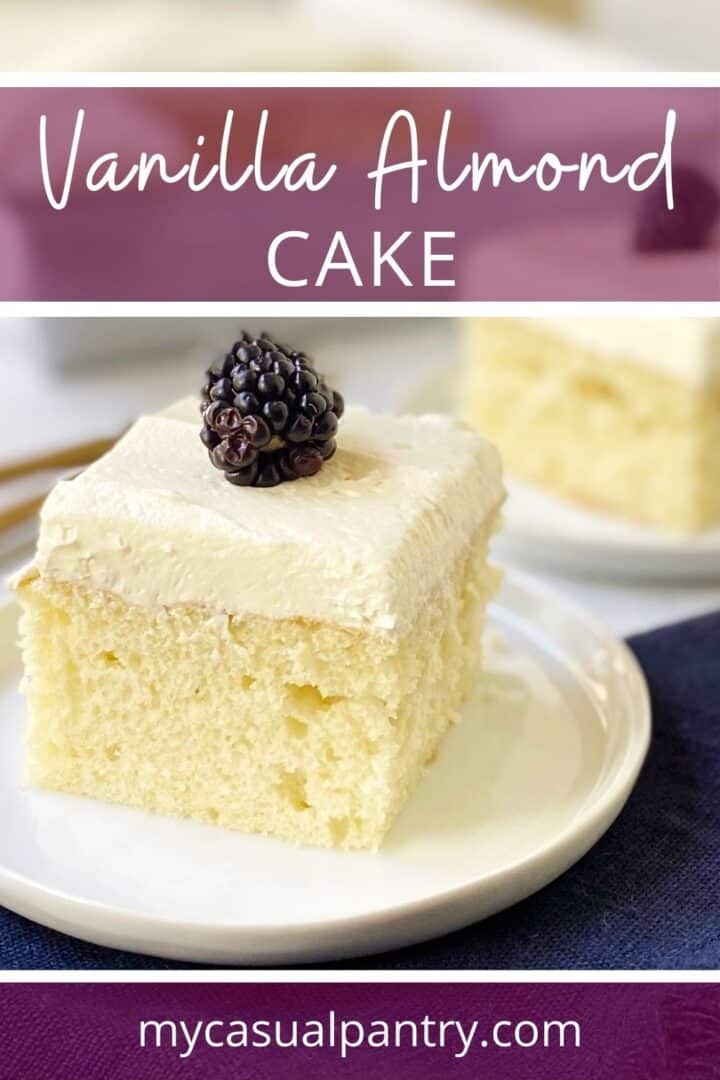 A slice of cake garnished with blackberries on a small plate.