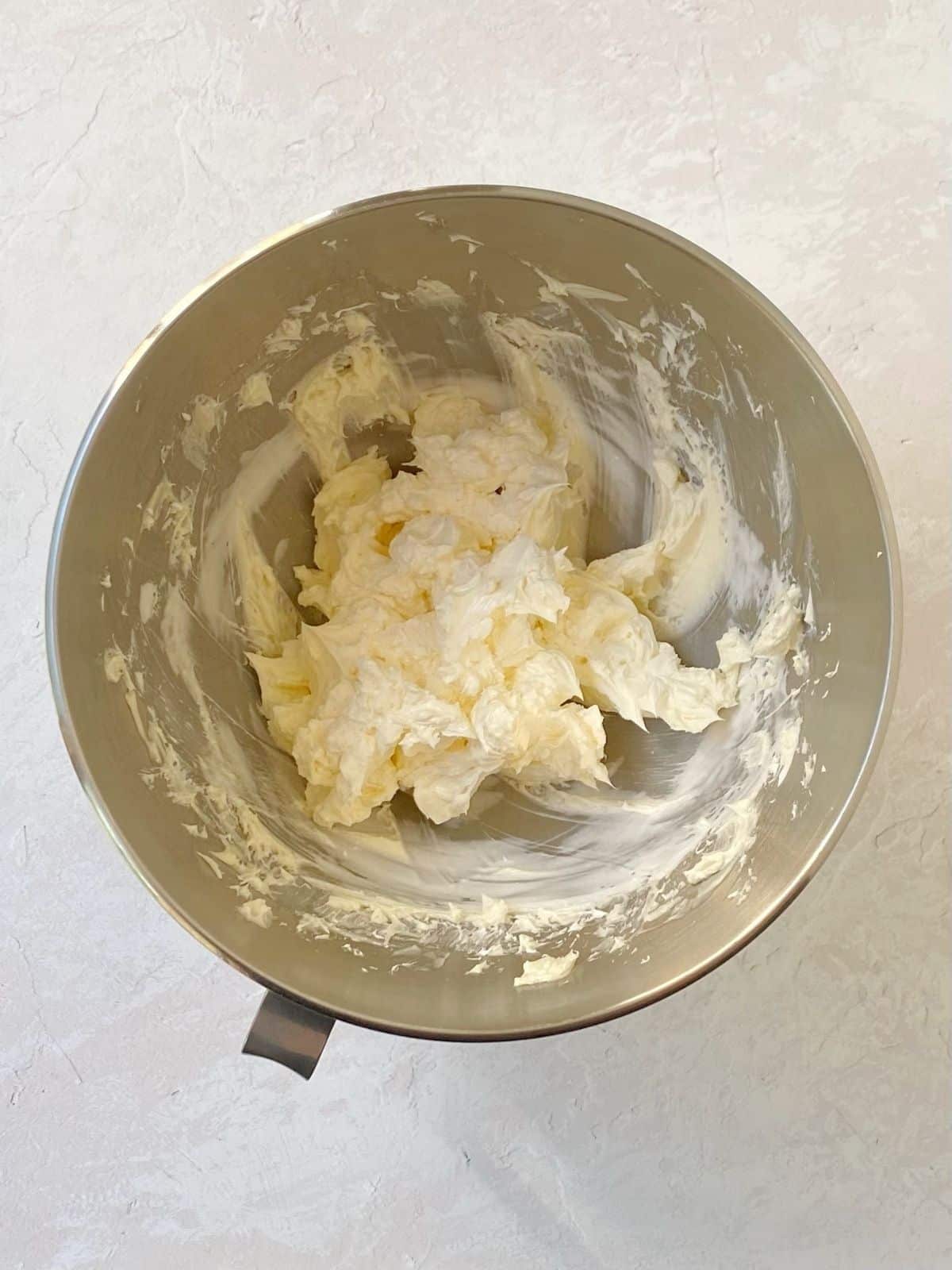 mixing butter and marshmallow cream together.