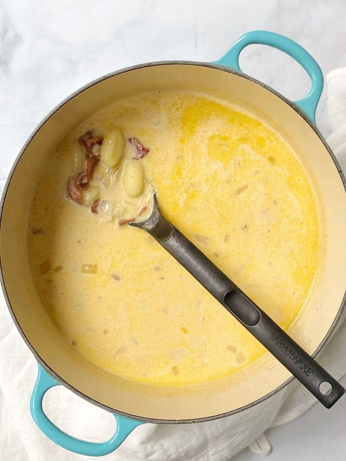 stir in cream and shredded cheese to potato gnocchi soup