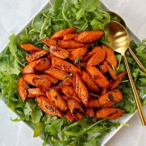 roasted carrots on a bed of arugula