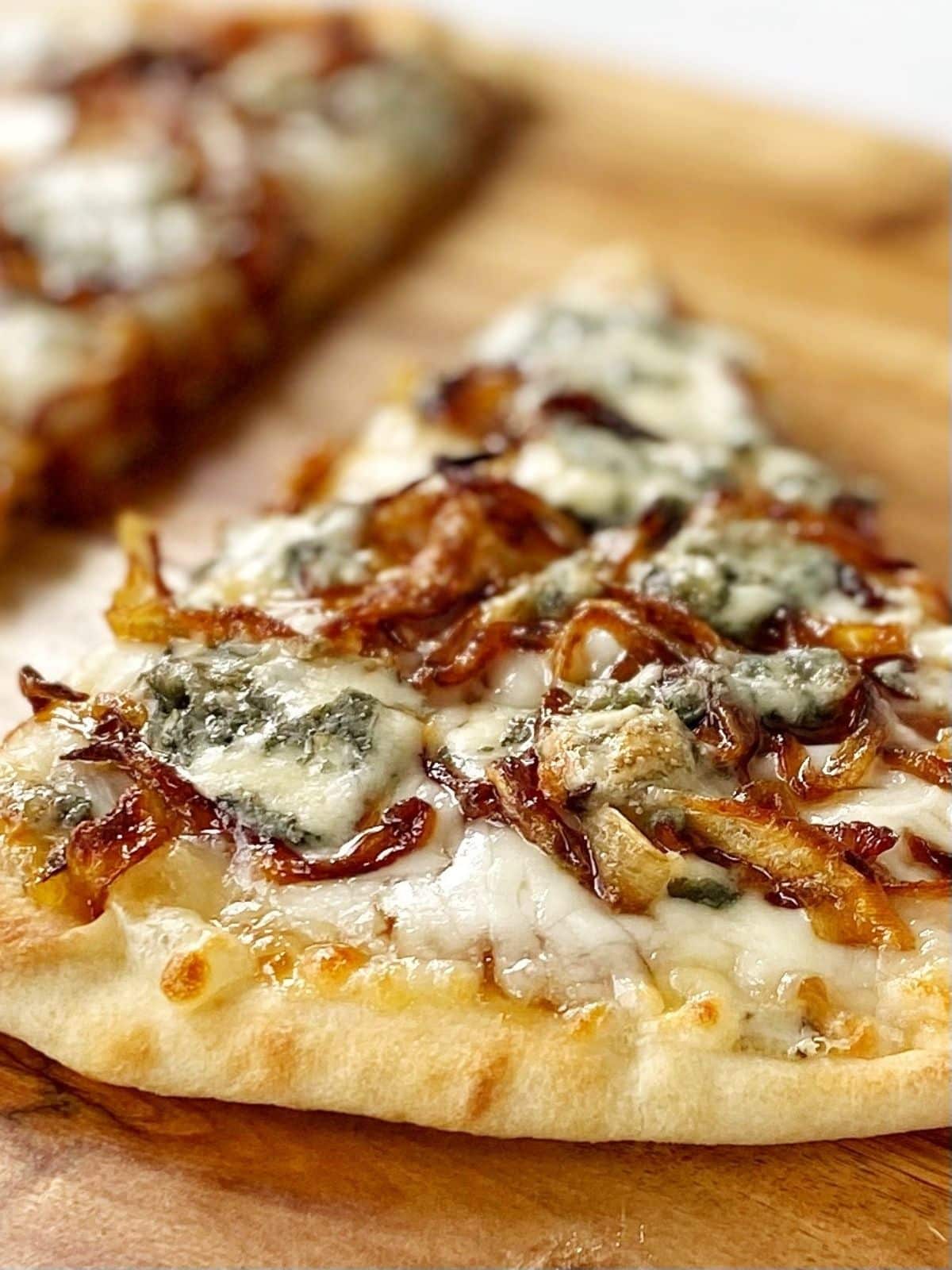 slice of onion, fig and blue cheese flatbread.