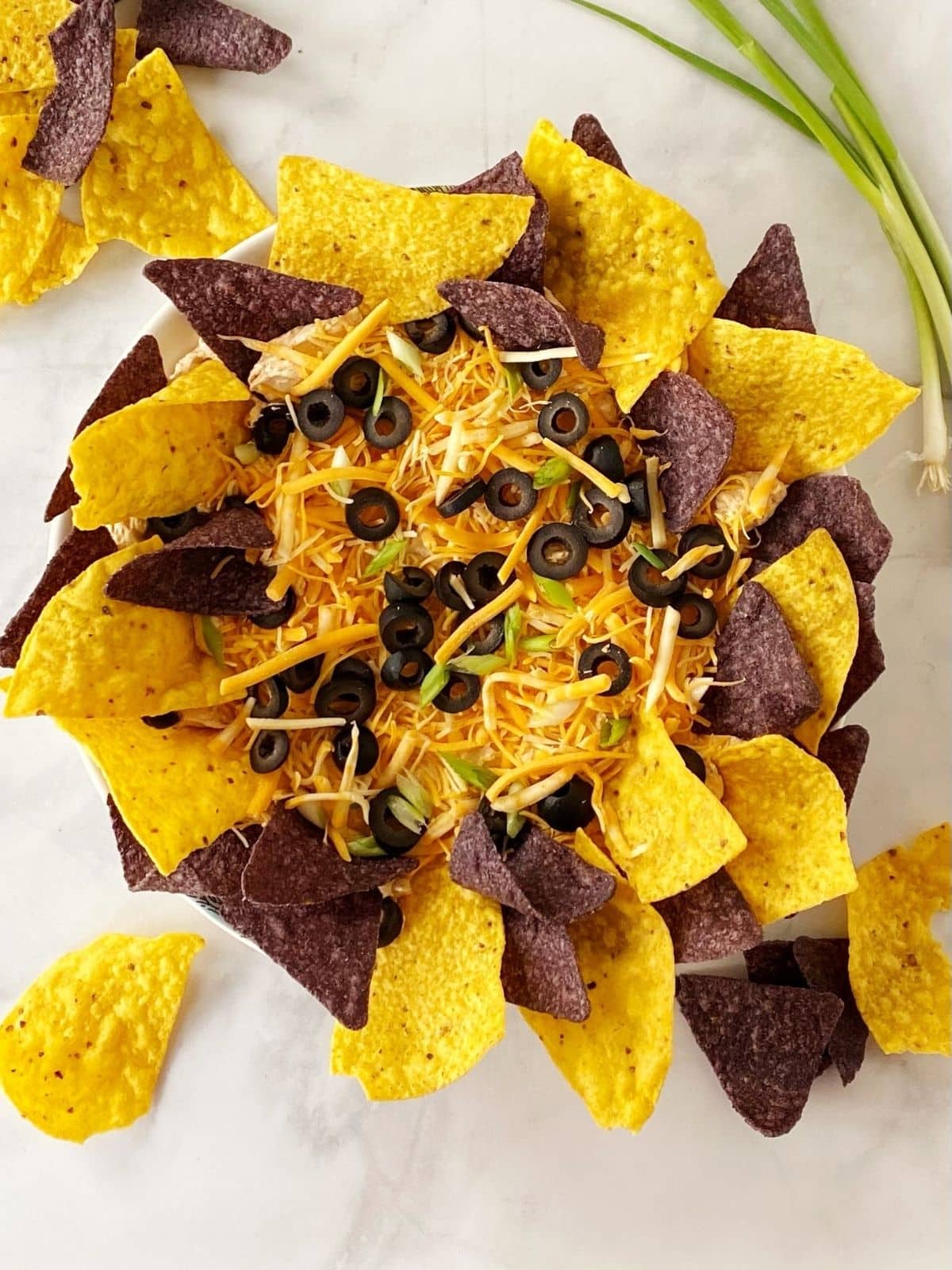 top down shot of taco dip with garnishes