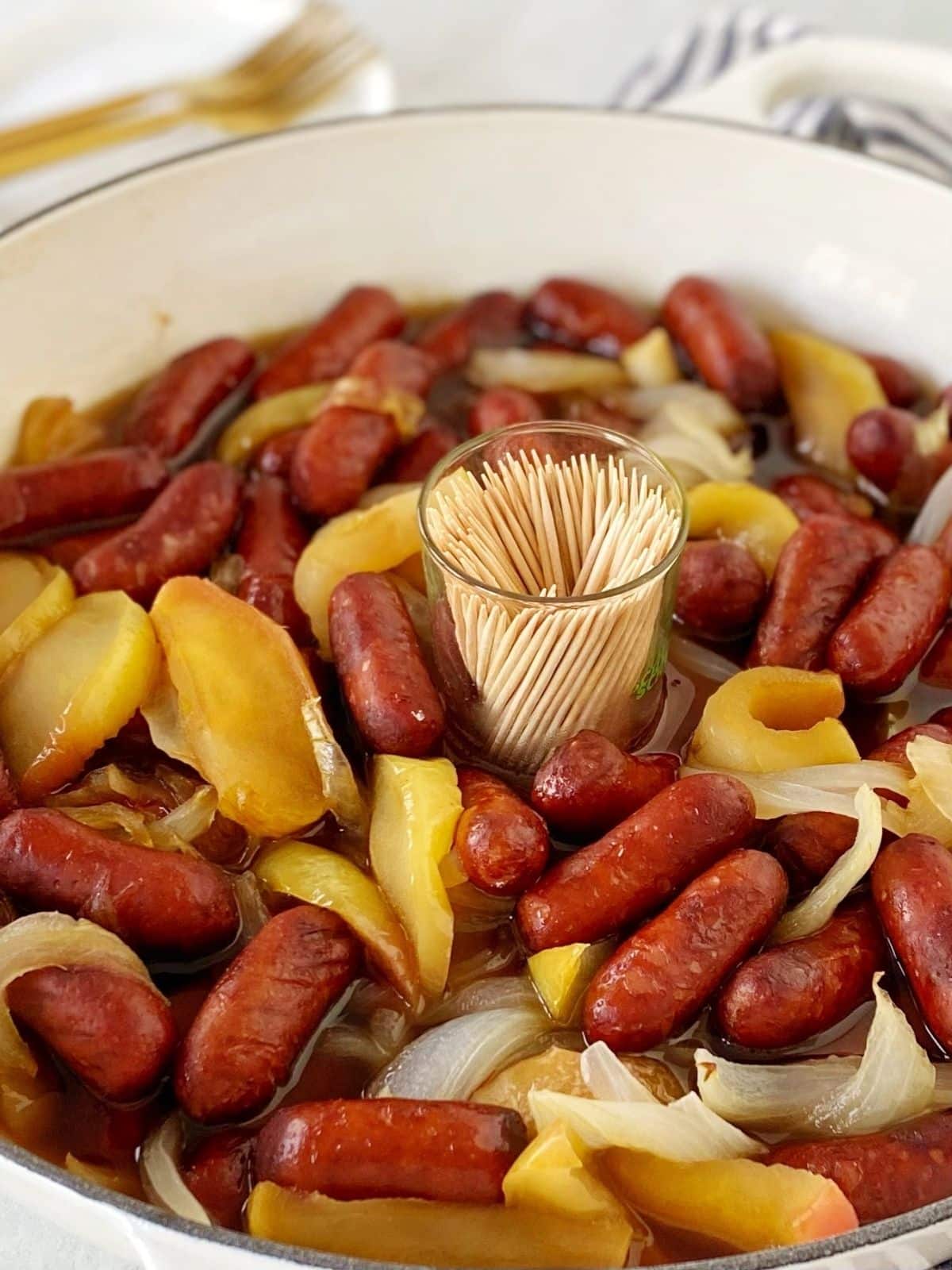 cocktail franks in pan with cup of toothpicks