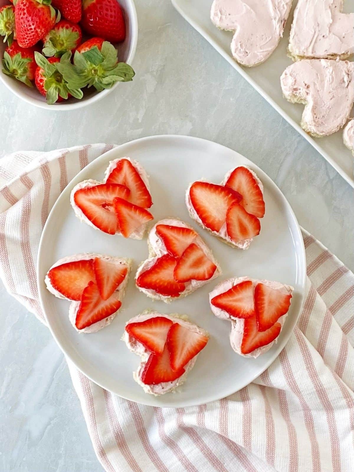 top down shot of open-faced strawberry tea sandwiches.