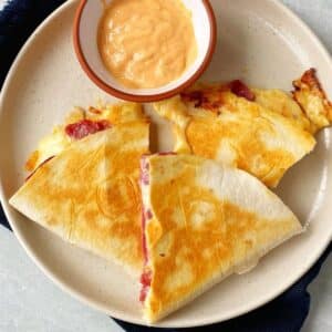 plate of quesadillas with dipping sauce
