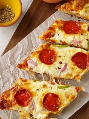 sliced ciabatta pizza bread on board.