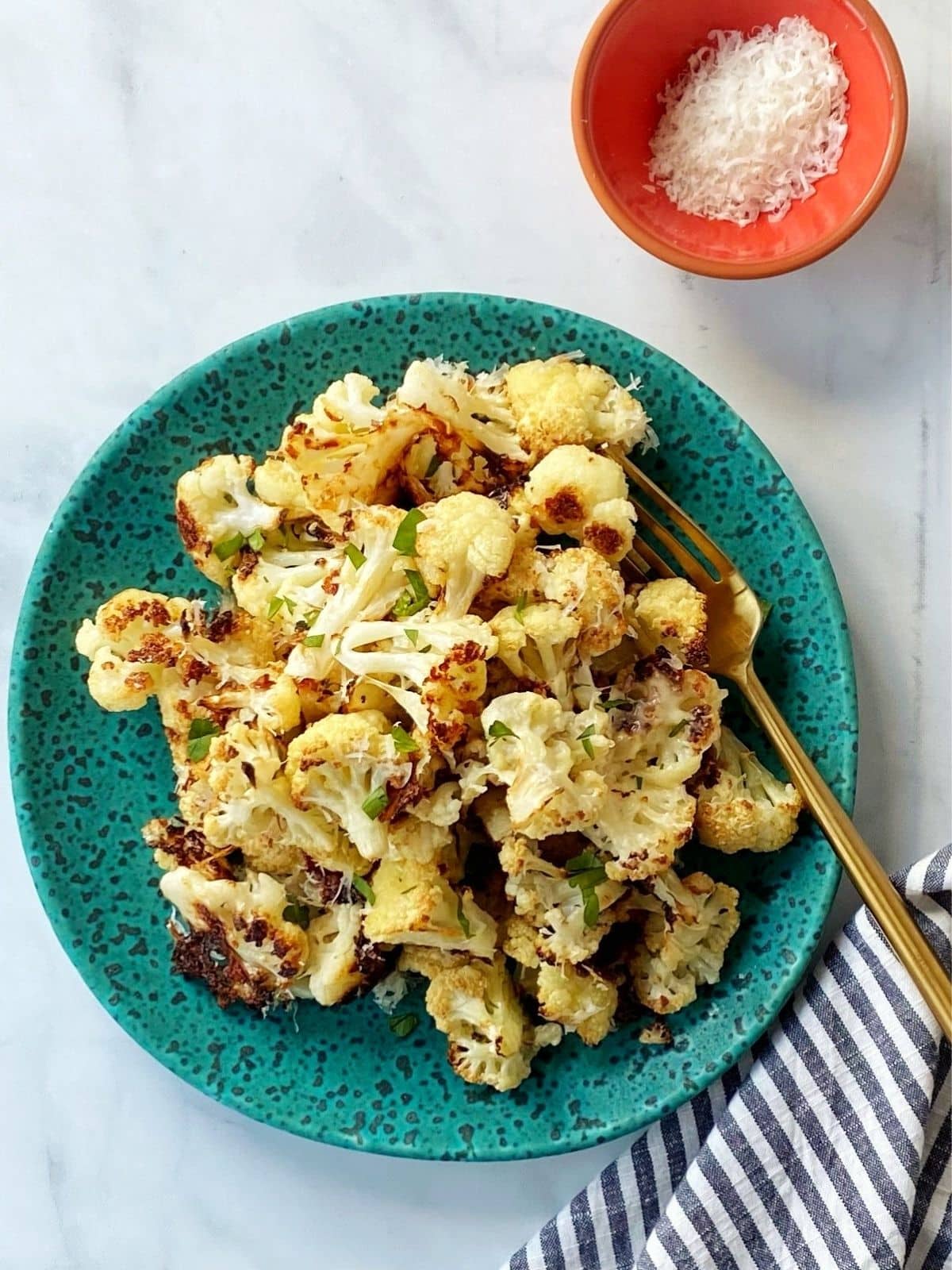 fork and plate of garlic parmesan cauliflower.