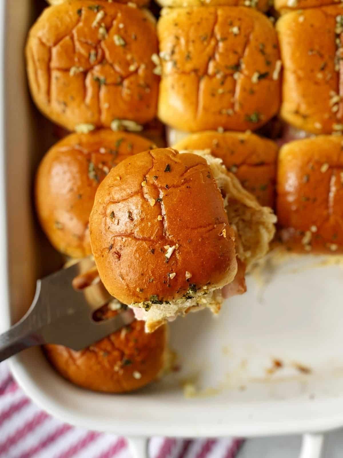 slider on spatula over casserole dish.