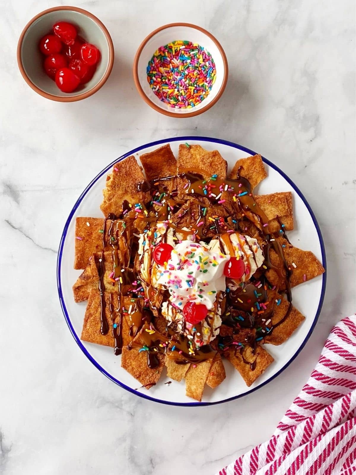 dessert nachos topped with cherries and sprinkles.