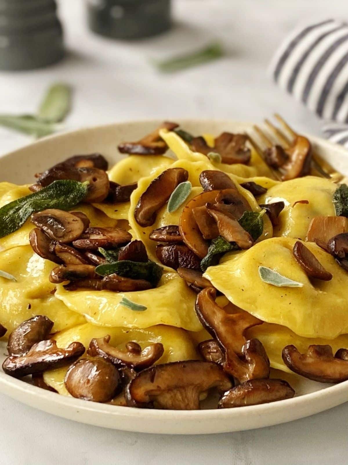 close up of mushroom ravioli on a plate.