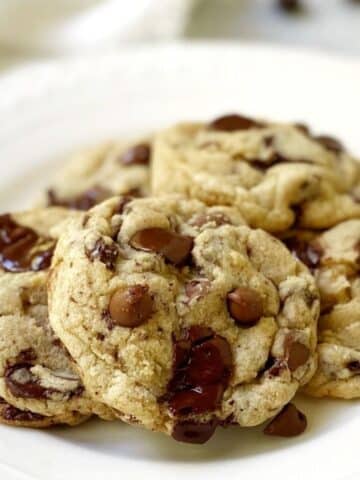 close up of triple chocolate chip cookies on a plate.