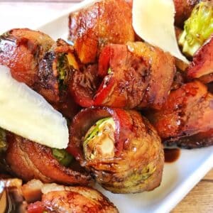 close up of plate of bacon wrapped brussels sprouts.
