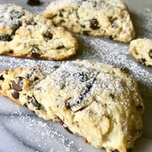 cherry chocolate almond scones dusted with powdered sugar.