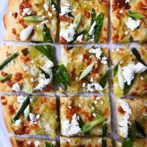 spring pizza sliced into squares.