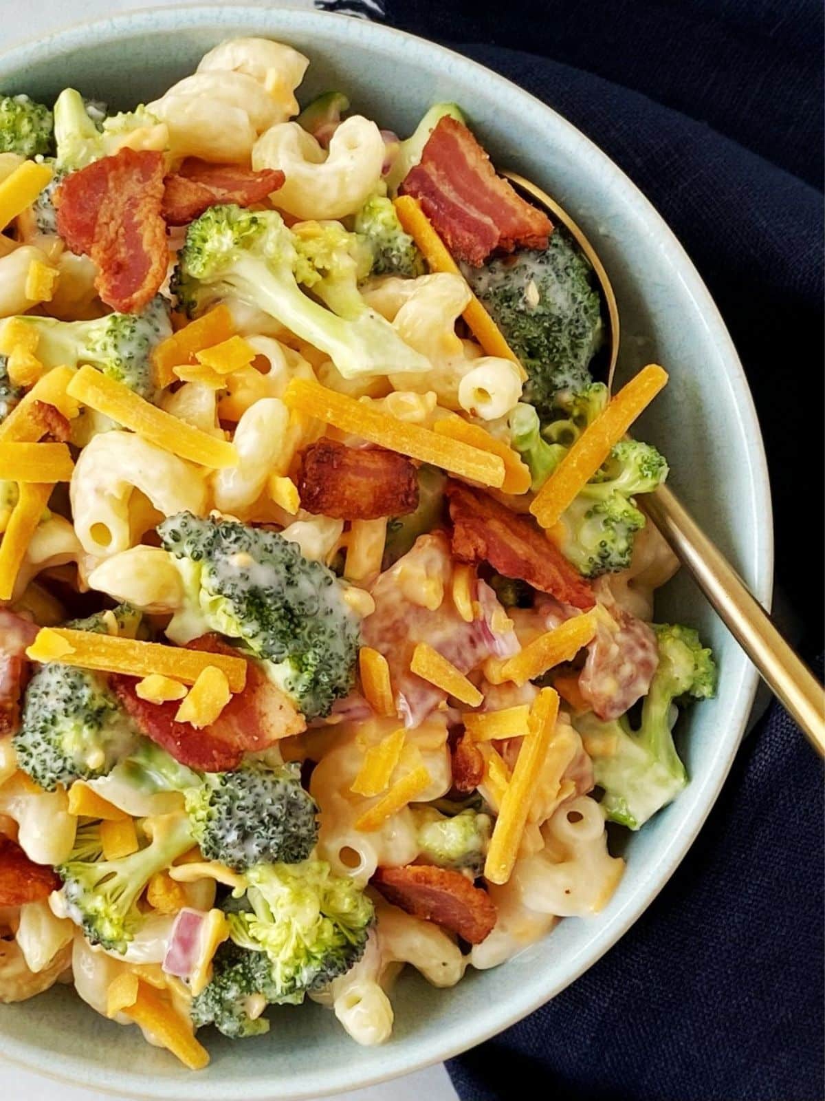 close up top down of broccoli pasta salad in a bowl.