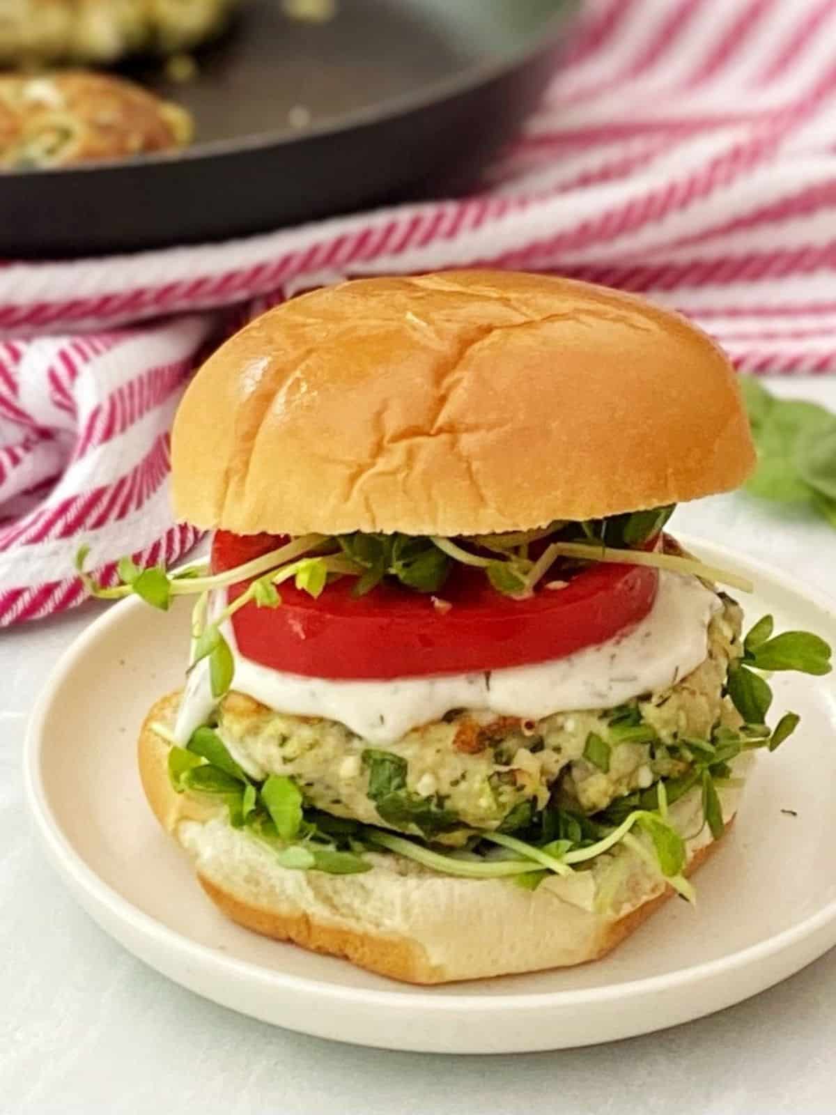 spinach feta chicken burger on a plate.