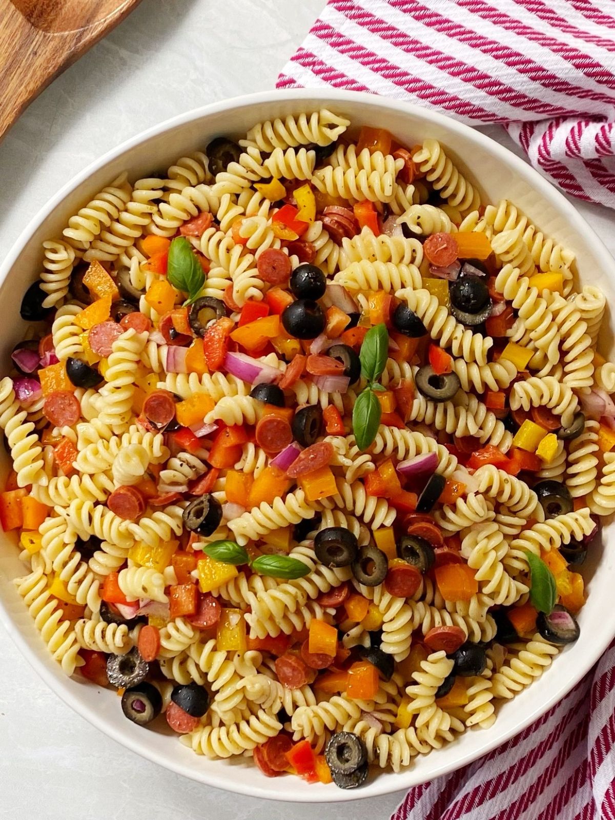 overhead shot of pasta salad in a white serving bowl.