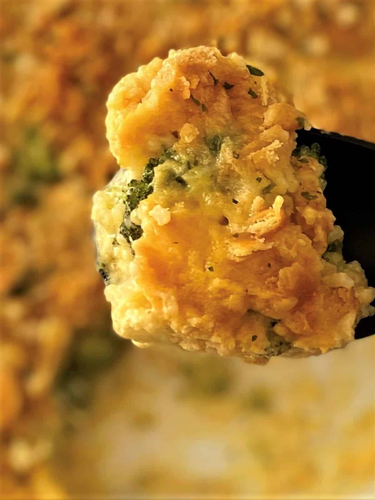 close up of spoonful of broccoli rice casserole.
