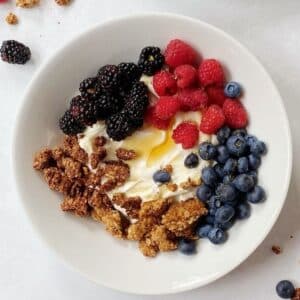 top down shot of bowl with yogurt, berries, and granola.