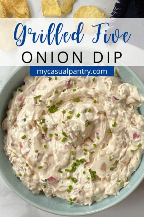 light blue bowl of grilled onion dip with potato chips.