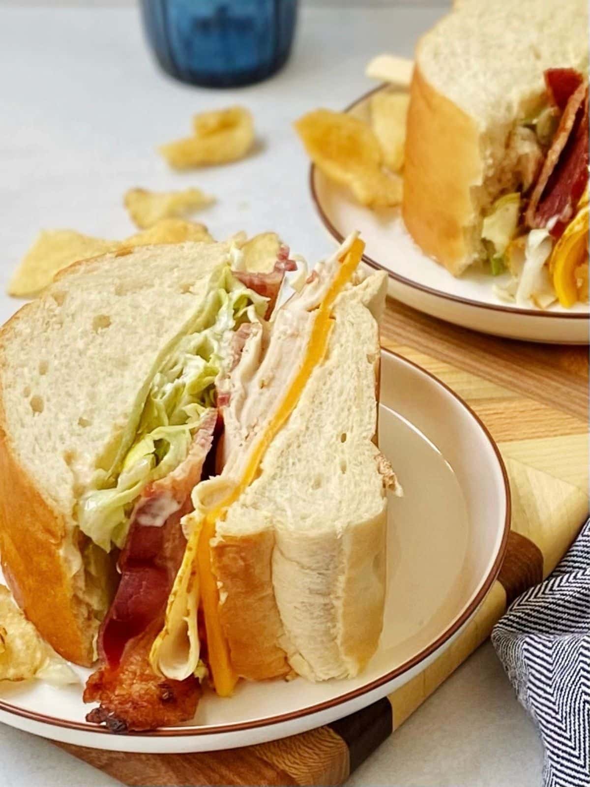 close up of wedges of sandwich on plates.