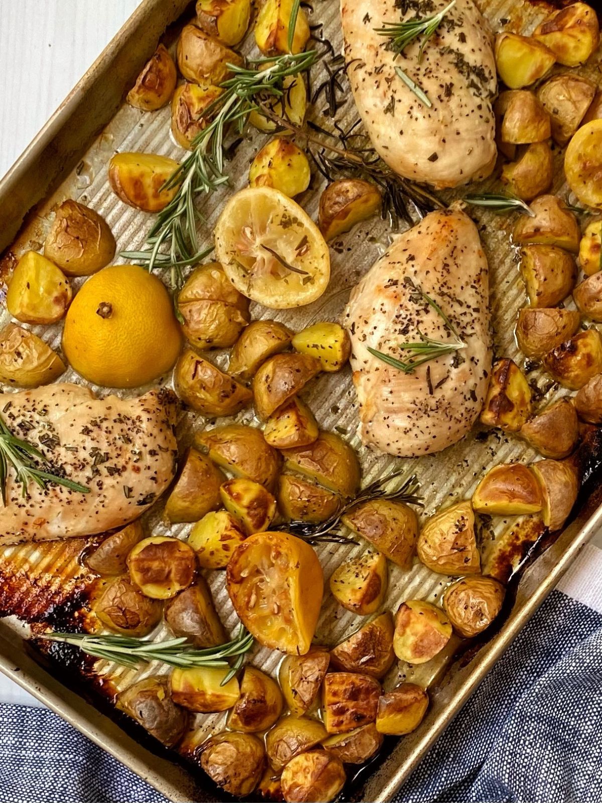 top down shot of roasted chicken and potatoes on sheet pan.