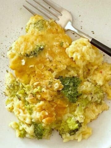close up of broccoli cheese casserole on a plate.