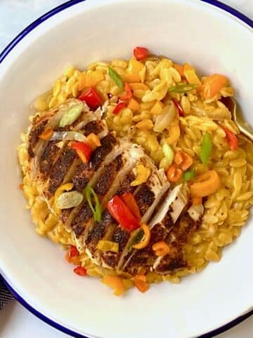 top down shot of bowl of cajun chicken orzo.