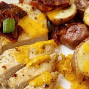 close up of chicken with potatoes cheese and bacon.