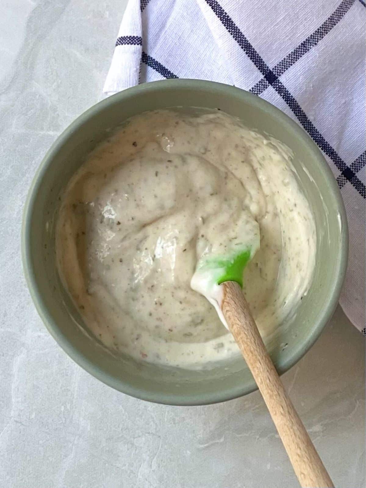 mixing dressing in a small bowl.