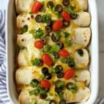 casserole of enchiladas topped with fixings.