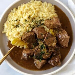 Mississippi beef with orzo on a plate with a fork.