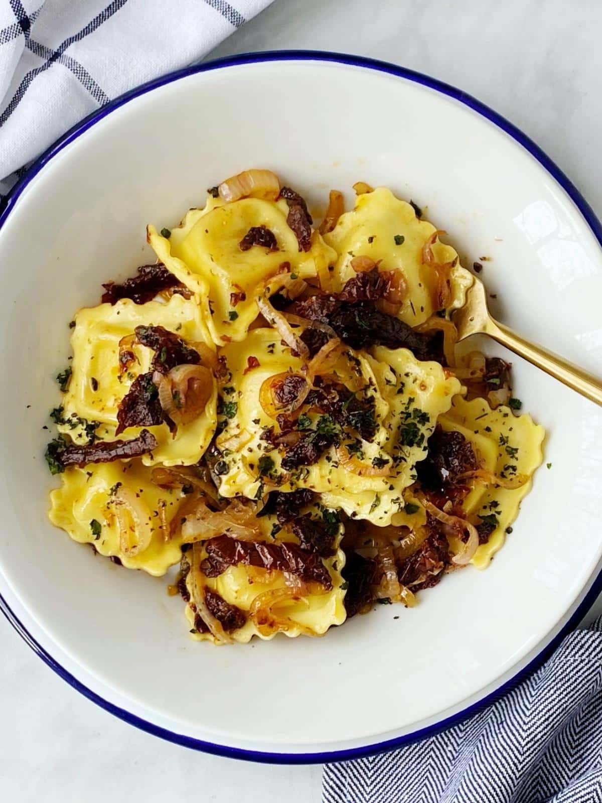 top down shot of bowl of ravioli with sun dried tomatoes.