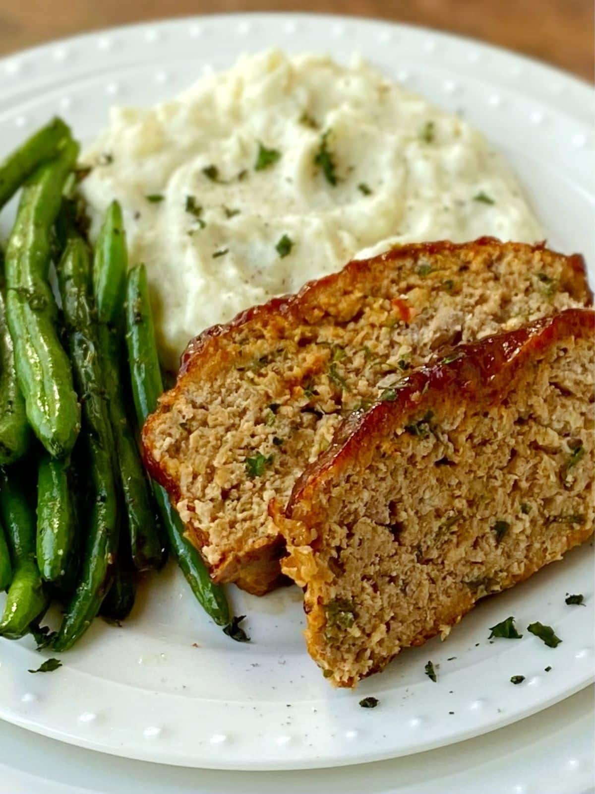 meatloaf and sides on a white plate.