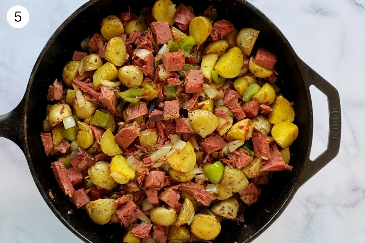 skillet with potatoes added to the corned beef veggie mixture.