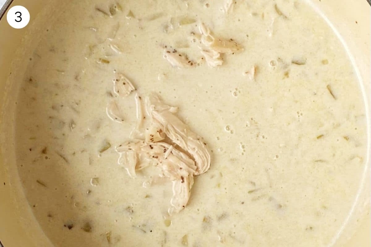 creamy coconut chili in a pot with chicken and white beans.