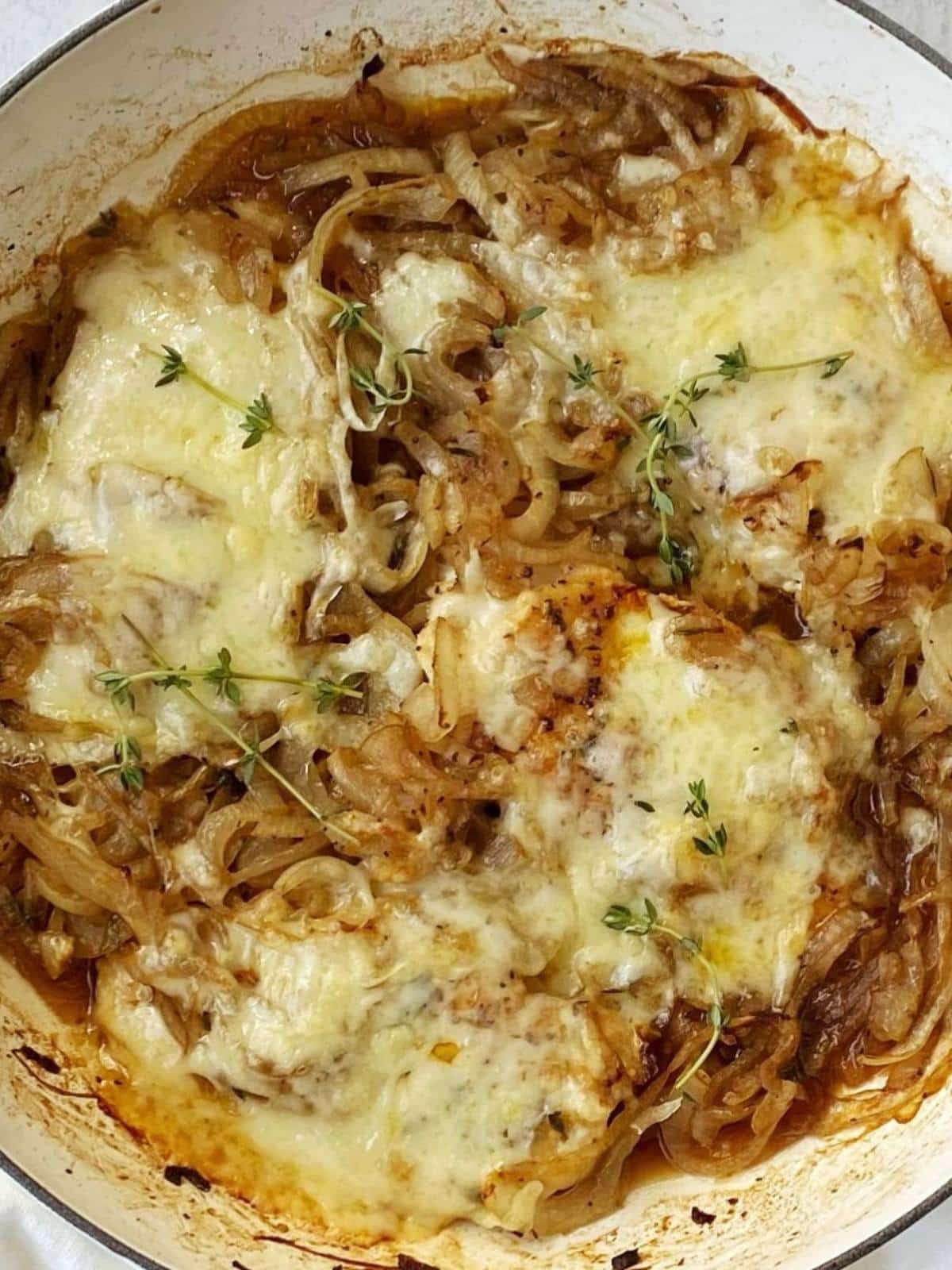 french onion chicken topped with melted cheese in the skillet.